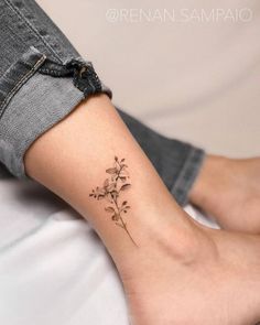 a small flower tattoo on the ankle