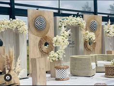 several wooden vases with flowers in them on display