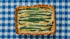 asparagus and cheese quiche on a blue checkered tablecloth