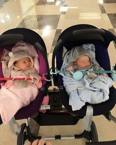 two babies in strollers with blankets on them