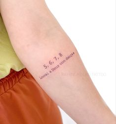 a woman with a tattoo on her arm that reads, 5 6 1 8 leave a beauty company