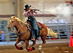 a man riding on the back of a brown horse