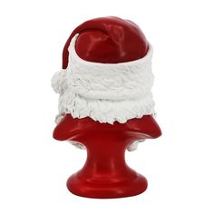 a red and white santa hat on top of a plastic head