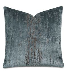 a blue velvet pillow with metallic foil on it