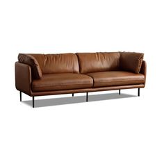 a brown leather couch sitting on top of a white floor next to a black metal frame