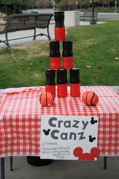 a table topped with cups and basketballs on top of a checkered table cloth