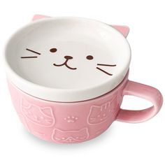 a pink cup with a cat face on it