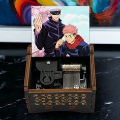 a wooden box with an image of naruto and sashirt in it