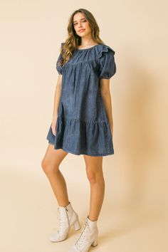 A lightweight denim mini dress featuring round neckline, ruffle at shoulder, puff sleeve, ruffled hemline and keyhole button closure Details Self: 100% Cotton Size & Fit - Model is 5`8" And Wearing Size Small - Measurements Taken From Size Small - Approx. Length: 30.5" Cotton Mini Dress For Day Out, Chic Denim Blue Mini Dress, Cotton Summer Mini Hem Dress, Chic Denim Mini Dress With Ruffles, Casual Mini Dress With Ruffles And Relaxed Fit, Casual Fitted Mini Dress With Mini Hem, Cotton Ruffles Mini Dress, Chic Light Wash Mini Denim Dress, Chic Dark Wash Mini Dress