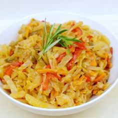 a white bowl filled with cabbage and carrots