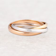 Posh, sophisticated, and chic, if you’re not adorned with a beret while running in slow motion in that art house perfume commercial, what are we even watching? This ring will show ‘em you’re once, twice, three times a lady: la dame of them all. Solid 14K Rose, Yellow, and White Gold or Black Zirconium, Solid 14K Rose, and Yellow Gold Intertwined Bands 1.6mm Wide Domed Design in Standard Fit with Polished Finish Sweetheart ring box included House Perfume, Perfume Commercial, Ring Storage, What Are We, Art House, Black Plates, Slow Motion, Ring Sizer, Silicon Bands