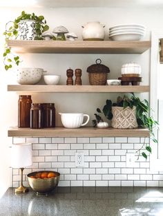 the shelves in this kitchen are filled with dishes