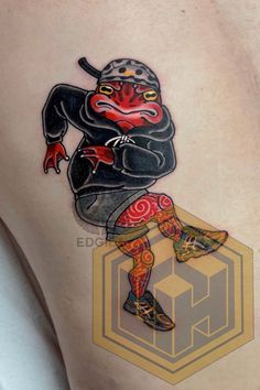 a tattoo on the back of a man's leg with an image of a demon