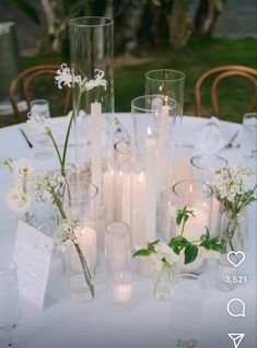 the table is set with candles, flowers and napkins for an elegant wedding reception