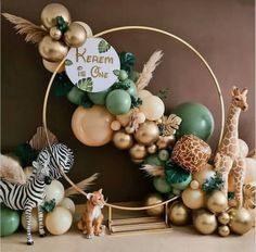 an animal themed birthday party with balloons, giraffes and zebras on the table