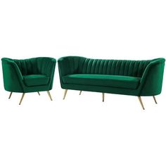 two green velvet sofas with gold legs