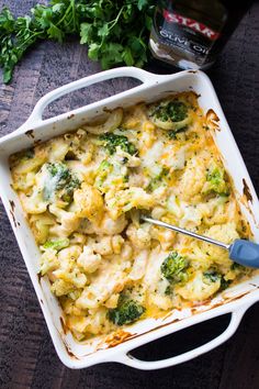 a casserole dish with broccoli and cheese in it on a table