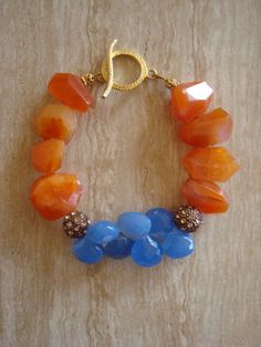 Beaded gemstone Beautiful faceted orange chalcedony beads accented with topaz colored pave beads and gorgeous blue chalcedony briolette beads. Finished with vermeil toggle clasp 6th Chakra Third Eye: Intuition, Mysticism, Understanding 2nd Chakra Sacral: Happiness, Orange Agate Gemstone Bead Bracelets, Orange Agate Gemstone Beads Bracelet, Orange Agate Gemstone Bracelets, Orange Carnelian Gemstone Bead Bracelets, Handmade Orange Agate Beaded Bracelets, Orange Carnelian Bracelets With Natural Stones, Orange Carnelian Beaded Bracelet With Gemstone, Orange Carnelian Gemstone Beaded Bracelets, Orange Carnelian Gemstone Beaded Bracelet