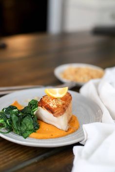 a white plate topped with food on top of a wooden table