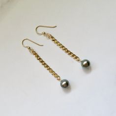 "Tahitian Pearl Earrings~ These elegant earrings have genuine pastel Tahitian pearls on 14k gold fill cuban chain. This listing is for the earrings in the first photos Pearls approx. 9mm. Dangles approx. 2\" from bottom of earwire Tahitian pearl jewelry~ https://www.etsy.com/shop/HanaMauiCreations?ref=hdr_shop_menu&section_id=7842721 Shop~ http://www.etsy.com/shop/HanaMauiCreations?ref=pr_shop_more International buyers please read our shipping policies before ordering~ POLICIES~ https://www.etsy Elegant Gold Tahitian Pearl Jewelry, Elegant Tahitian Pearl Chain Jewelry, Classic Gold Tahitian Pearl Earrings, Gold Tahitian Pearl Earrings Gift, Gold Tahitian Pearl Drop Earrings, Gold Tahitian Pearl Earrings For Anniversary, Elegant Gold Tahitian Pearl Earrings, Gold Tahitian Pearl Teardrop Jewelry, Gold Tahitian Pearl Jewelry With Pearl Charm