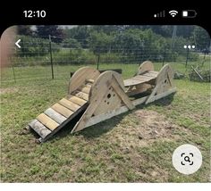 a wooden slide in the middle of a field