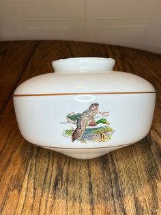 a white casserole dish with an image of a bird on the front and bottom