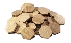 wooden hexagonals are stacked on top of each other in the middle of a pile