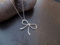 "\"Forget Me Knot\" hand formed sterling silver bow necklace made using sterling silver wire, gently hammered and hand polished. It hangs on an 18\" sterling silver cable link chain. The bow measures about 1\" x 3/4\". Makes a great gift for that special someone to remind them never to forget the love you have together. It will come in a little ribbon tied gift box. Each necklace is custom made upon ordering and will be on it's way to you from my workbench to your door within 3-5 days. Makes a g Silver Sterling Silver Necklace With Bow, Minimalist Silver Jewelry With Bow, Tie Gift Box, Knot Bow, Bow Necklace, Tie Gifts, Silver Bow, Hand Stamped Jewelry, Knot Necklace