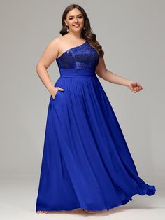 a woman in a blue dress posing for the camera with her hands on her hips