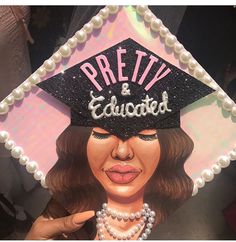 a close up of a cake with a woman wearing a graduation cap