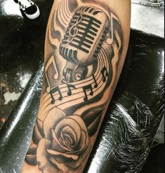 a black and white photo of a microphone with music notes on it's arm