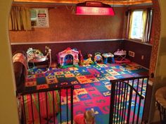 a child's play room with toys on the floor and rugs covering the floor