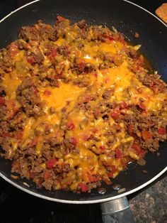 a skillet filled with cheese and ground beef