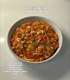 a white bowl filled with food on top of a table