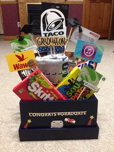 a graduation gift box filled with candy and congratulations stickers for the graduate's day