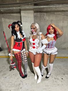 three women dressed in costumes standing next to each other