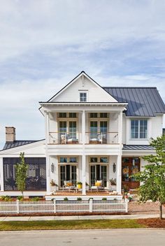 a large white house sitting on the side of a road