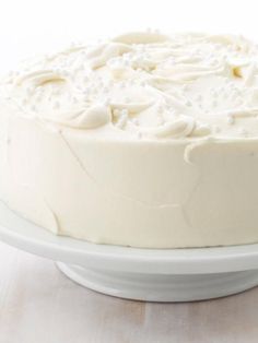 a frosted cake sitting on top of a white plate