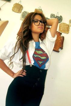 a woman wearing glasses and a superman tie