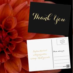 a close up of a flower with a thank you card on it's side