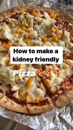 a pizza sitting on top of aluminum foil covered in cheese and toppings with the words how to make a kidney friendly pizza