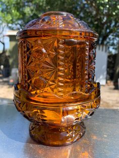 an orange glass container sitting on top of a table