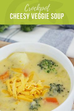 a white bowl filled with cheese and broccoli soup on top of a wooden table