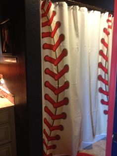 a baseball themed shower curtain in a bathroom