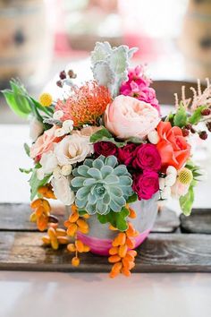 a bouquet of flowers sitting on top of a wooden table next to an instagram page