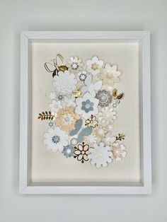 a white framed artwork with flowers on it