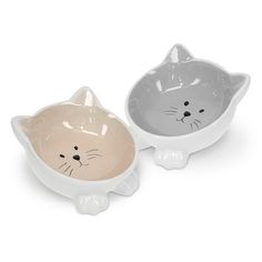 two bowls with cats on them sitting next to each other