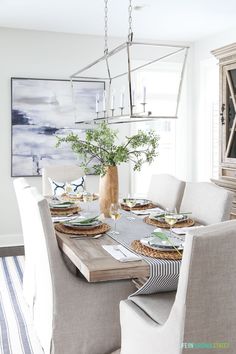 the dining room table is set with place settings