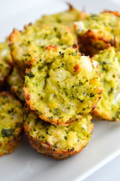 broccoli and cheese muffins stacked on top of each other in a white plate