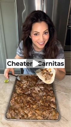 a woman holding a spoon over a pan filled with food